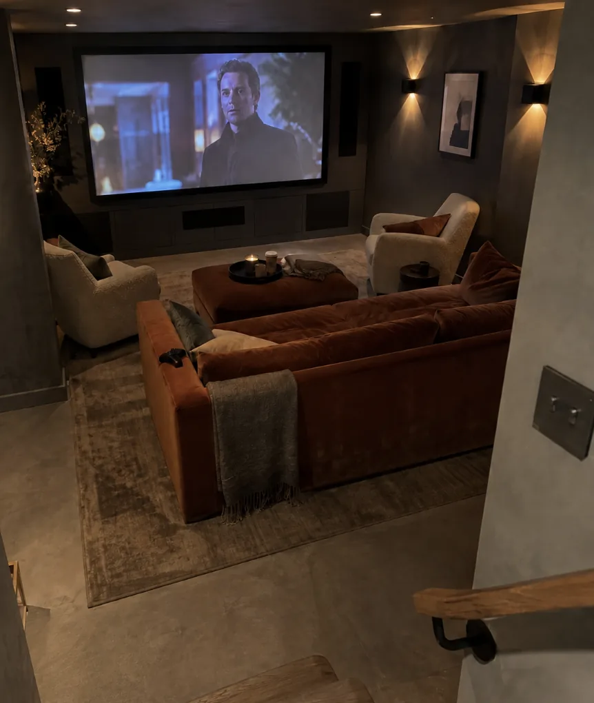 Home cinema room in Kent with the projector running